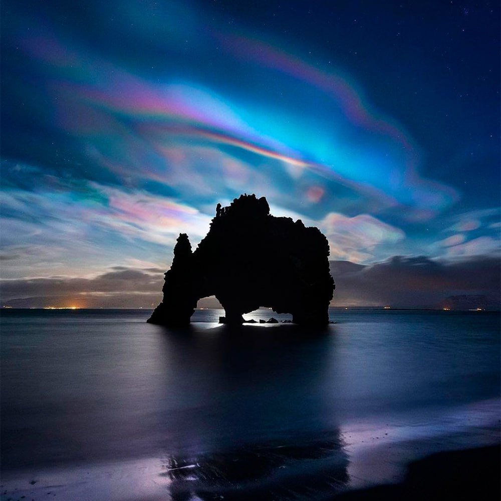 Mesmerizing Iridescent Clouds Enhance Hvitserkur Rock Beauty