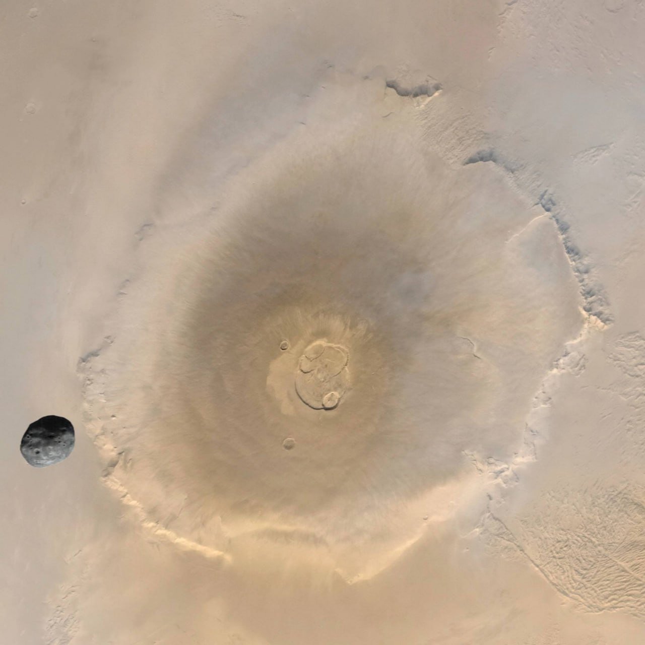Martian Moon Phobos and Olympus Mons Captured in Image

The image showcases the moon Phobos and the Martian mountain Olympus, captured by the "Mars Express" spacecraft.

Phobos, one of Mars' two moons (alongside Deimos), is named after the ancient Greek god Phobos, meaning "Fear." It has dimensions of 26.8×22.4×18.4 km.