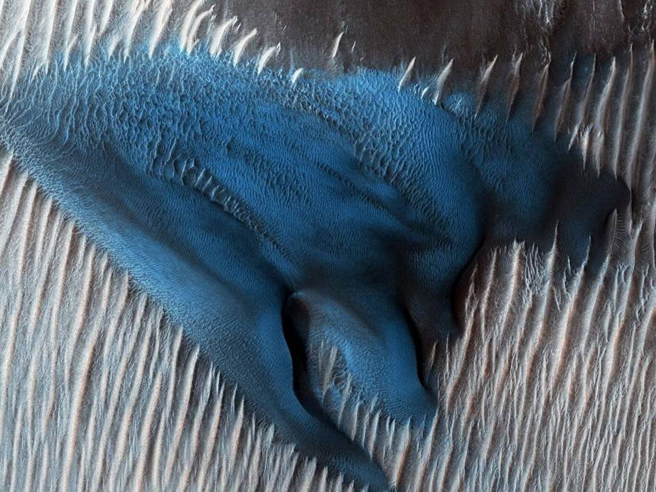 Blue Dunes on Mars

The stunning blue hue of the dunes on Mars is caused by the presence of iron-rich minerals like olivine and pyroxene that are exposed on their surface.

These minerals create a unique and striking visual appearance, offering a glimpse into the fascinating geological composition of the Martian landscape.