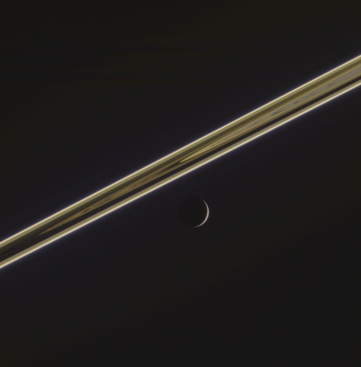 Dion's delicate scythe captured beneath Saturn's rings by Cassini spacecraft

A striking archival image processed by Jason Major showcases Dion, one of Saturn's moons, appearing like a delicate scythe beneath the planet's iconic rings. The Cassini spacecraft's detailed observation reveals the intricate beauty and celestial wonders present within our solar system.

This captivating image provides a unique perspective on the cosmic ballet of Saturn's rings and its diverse collection of moons. The careful processing by Jason Major highlights the intricate details of Dion against the backdrop of the gas giant's majestic rings, offering a glimpse into the mesmerizing complexity of our cosmic neighborhood.