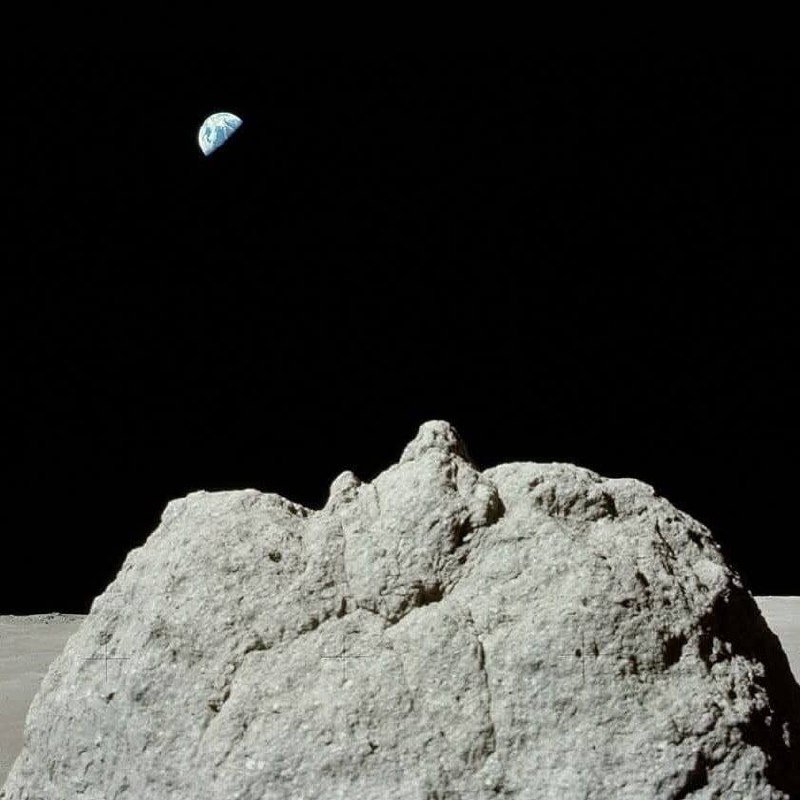 Beautiful Earth (the "blue marble") above the gray lunar rocks.

Photograph from the Apollo 17 expedition.