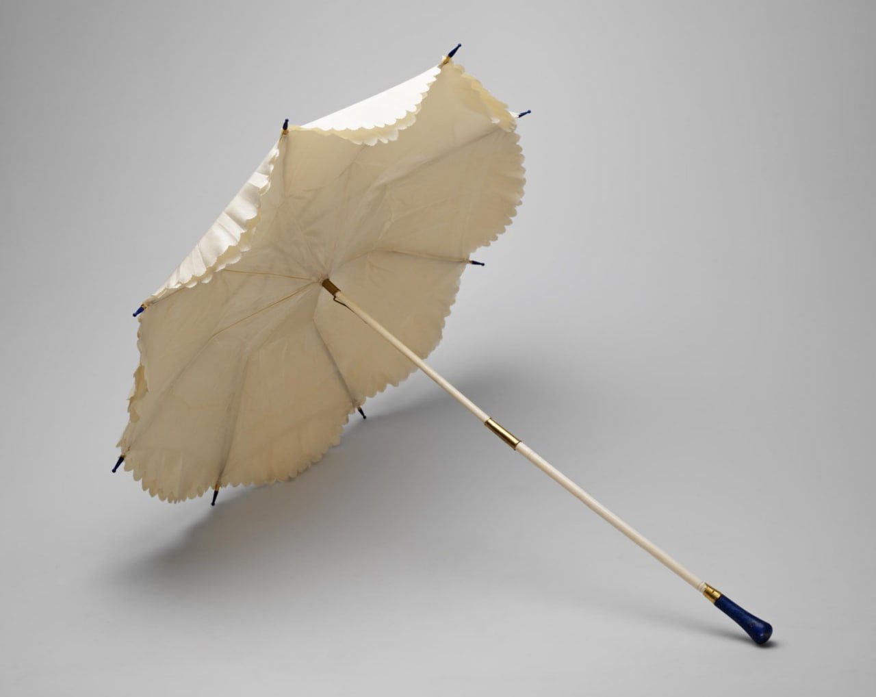 Mastercrafted 19th Century Umbrella in Saint Petersburg A beautifully crafted umbrella from the 1870s-1880s in Saint Petersburg is attributed to Samuel Arndt. The umbrella features a handle frame made of gold, lapis lazuli, bone, silk, and possibly whale whisker, all mounted on a base metal structure. The umbrella measures 67.0 cm in length and has a maximum handle width of 2.2 cm.

This exquisite piece is a testament to the craftsmanship of the era, showcasing intricate turning work and meticulous mounting techniques. The combination of luxurious materials used in its construction highlights the attention to detail and artistry of Samuel Arndt. Displayed as part of the Museums of the Moscow Kremlin collection, this umbrella offers a glimpse into the opulence and elegance of the 19th century in Russia.